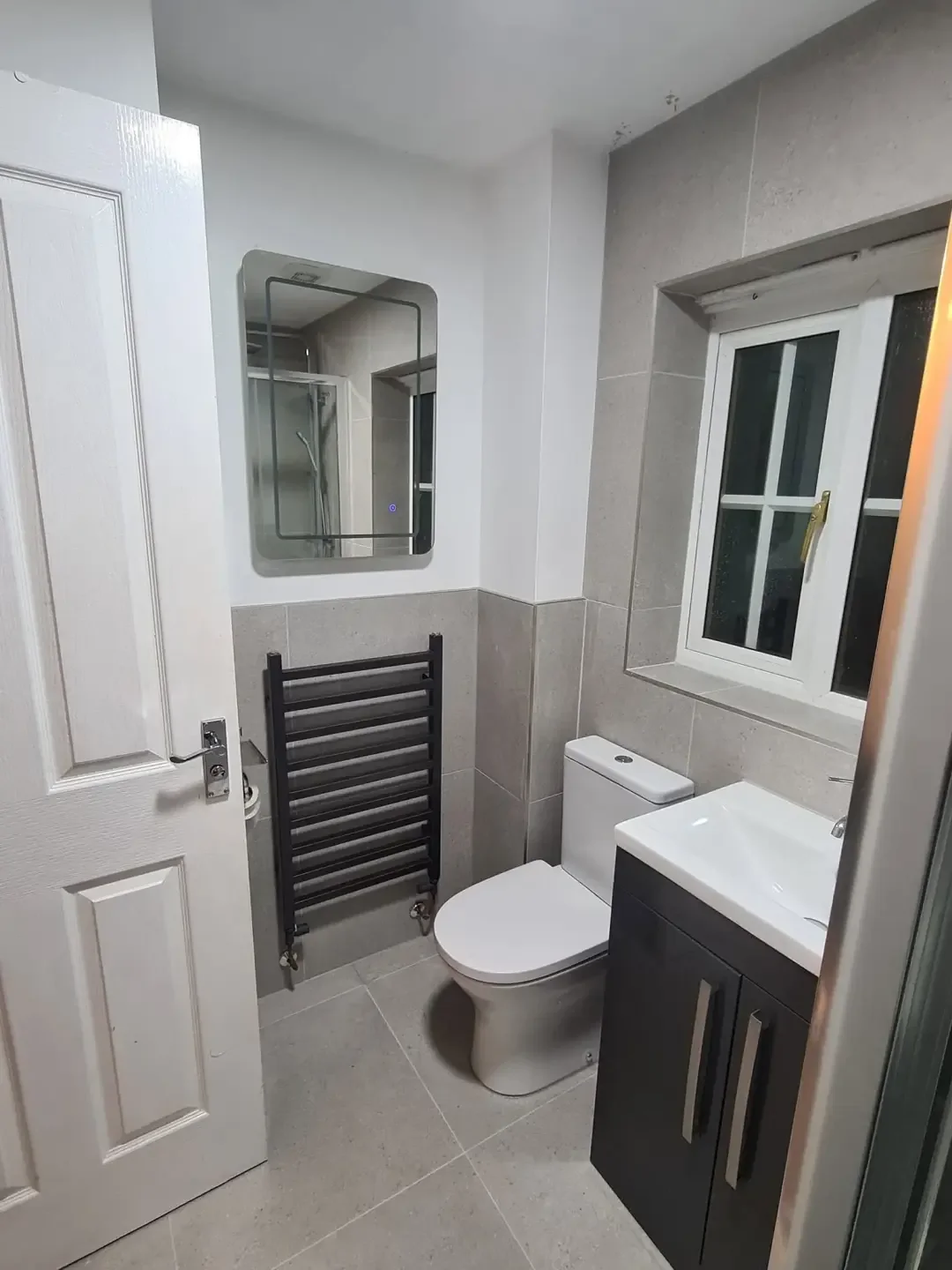 Black ladder towel radiator fitted in a Preston bathroom